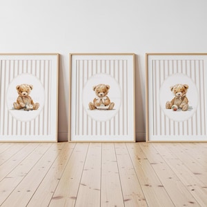May include: Three framed prints featuring watercolor illustrations of teddy bears. Each bear is depicted in a seated position, with one holding a toy car, another holding a small house, and the third with a ball. The backgrounds have a striped pattern.