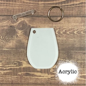 May include: White acrylic blank keyring with a key ring and a jump ring. The keyring is shaped like a teardrop. The word "Acrylic" is written in black text on a white background.