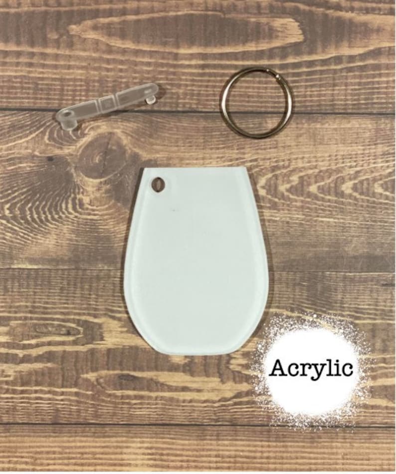 May include: White acrylic blank keyring with a key ring and a jump ring. The keyring is shaped like a teardrop. The word "Acrylic" is written in black text on a white background.