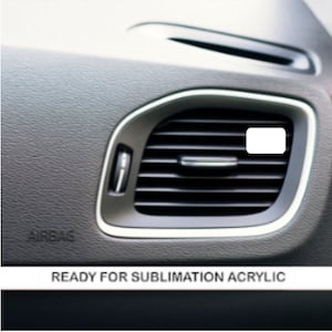 May include: A close-up of a black car air vent with a silver trim. The vent has a rectangular opening with a series of horizontal slats. The vent is labeled "READY FOR SUBLIMATION ACRYLIC".