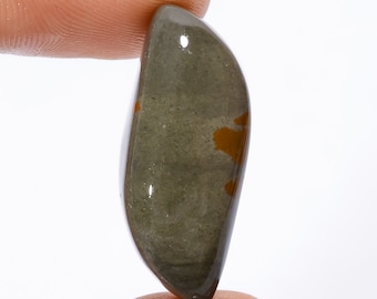 May include: A smooth, polished, grey and brown gemstone with a teardrop shape.
