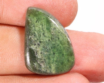 May include: A smooth, green gemstone with a mottled pattern. The stone is shaped like a teardrop and has a polished finish.
