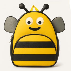 May include: A yellow and black bee-themed backpack with a smiling face, antennae, and wings. The backpack features black stripes on the lower half and a yellow top with a zipper closure. The backpack has a small yellow handle.