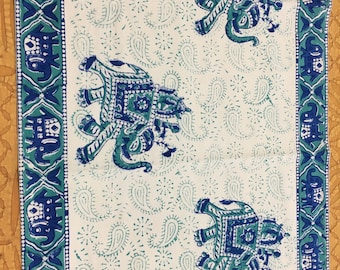 May include: White fabric with a blue and green paisley pattern and a border of blue and green elephants.