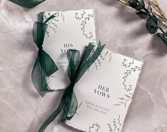 May include: Two rectangular vow booklets with deckled edges, featuring green botanical illustrations. One booklet reads HIS VOWS, the other HER VOWS, both with SOPHIE & MICHAEL 9TH JUNE 2024. Each is tied with a dark green sheer organza ribbon.