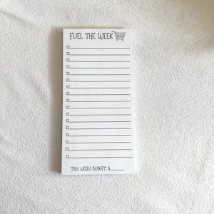 May include: A white notepad with the text "FUEL THE WEEK" and a shopping cart icon. The notepad has a list of checkboxes and the text "THIS WEEKS BUDGET: $".