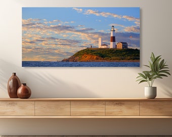 May include: A white and red lighthouse with a white roof stands on a grassy cliff overlooking the ocean. The sky is blue with white clouds. The lighthouse is lit up by the sun, casting a warm glow on the scene.