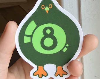 May include: A sticker in the shape of a green bird-like figure with orange feet and beak. The sticker has a large green circle with the number 8 inside. An exclamation point and a small dot are on the left and right sides of the circle.