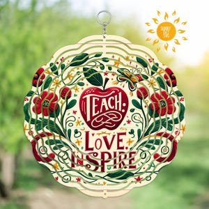 May include: A colorful wind spinner with a red apple and the words "Teach: Love Inspire" in a white circle surrounded by green leaves and red flowers.