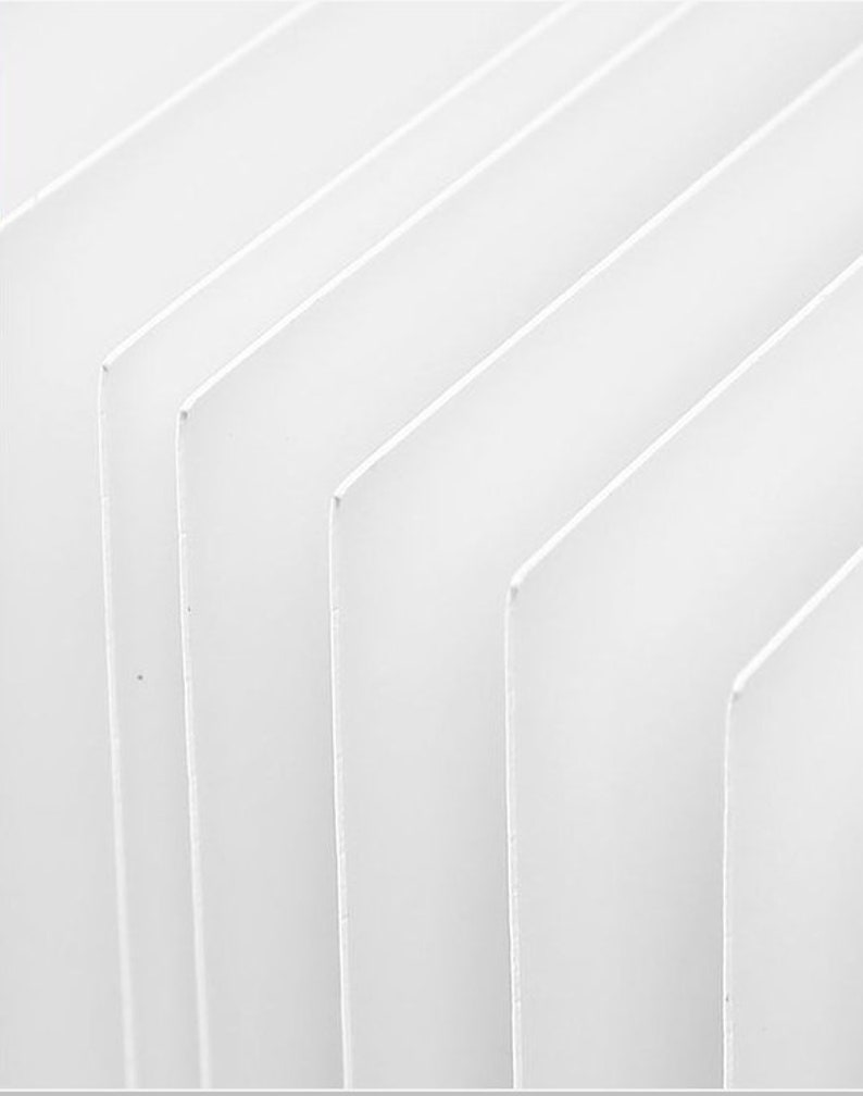May include: A close-up of a white, textured surface with a series of parallel lines creating a geometric pattern.