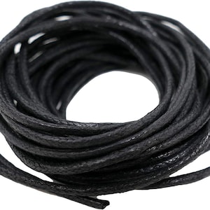 May include: A spool of black waxed cotton cord. The cord is tightly wound and appears to be about 6 mm thick.