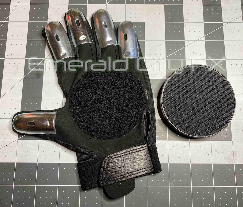 Sparking slider gloves for Halloween and haunted house featuring metal fingertips and sparking pucks. Gloves spark and make sound. Gloves have Velcro palms for easy replacement of sparking pucks.