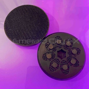 May include: A white ceramic mug with a black handle and the text "But First, Coffee" in a black, handwritten-style font. The mug is on a white surface.