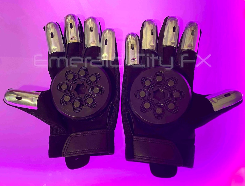 Sparking slider gloves for Halloween and haunted house featuring metal fingertips and sparking pucks. Gloves spark and make sound. Purple background.