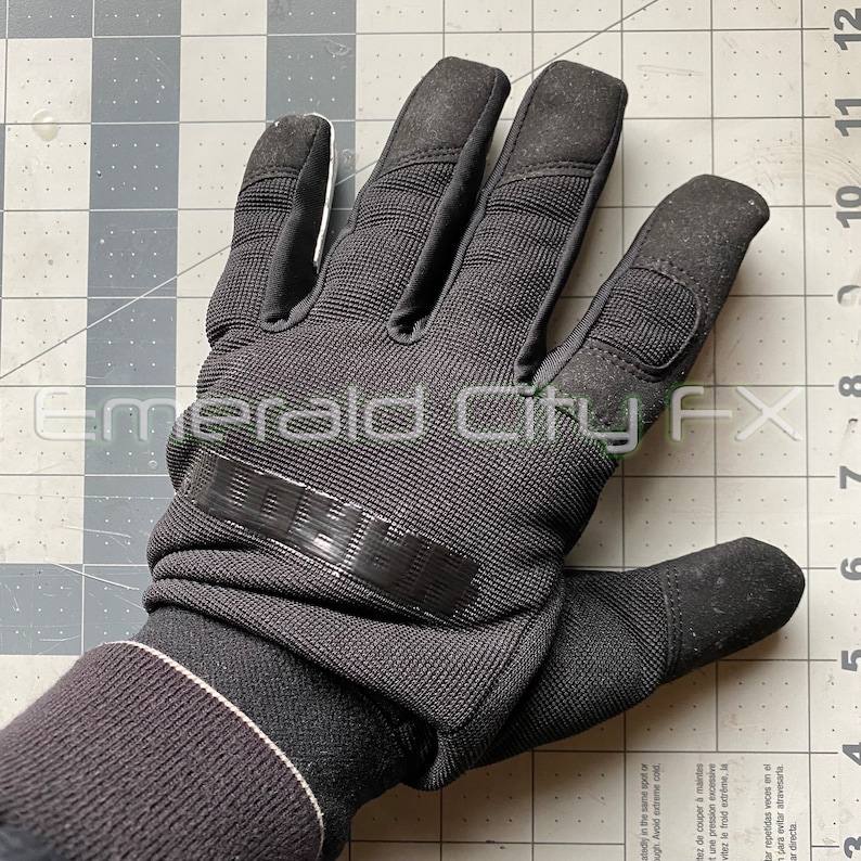 Back view of sparking slider gloves for Halloween and haunted house featuring metal fingertips and sparking pucks. Gloves spark and make sound.