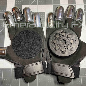 Sparking slider gloves for Halloween and haunted house featuring metal fingertips and sparking pucks. Gloves spark and make sound. Gloves have Velcro palms for easy replacement of sparking pucks.