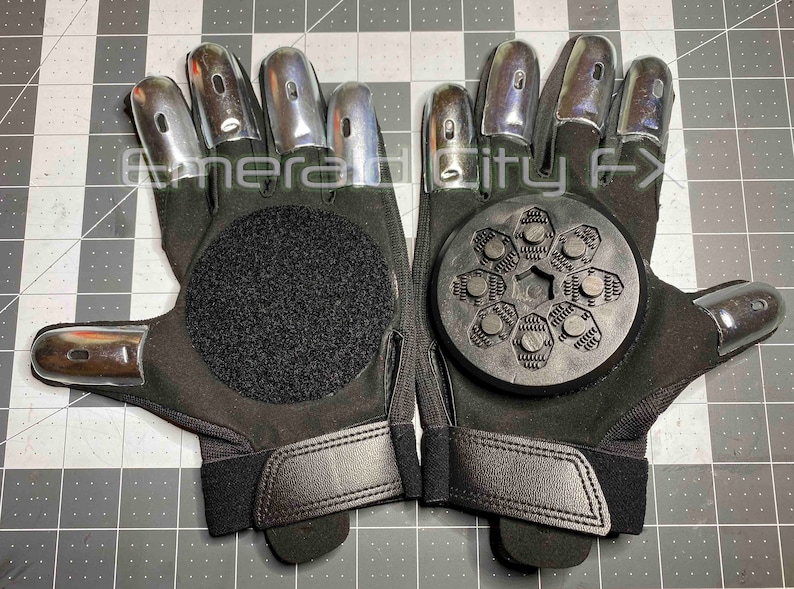 Sparking slider gloves for Halloween and haunted house featuring metal fingertips and sparking pucks. Gloves spark and make sound. Gloves have Velcro palms for easy replacement of sparking pucks.