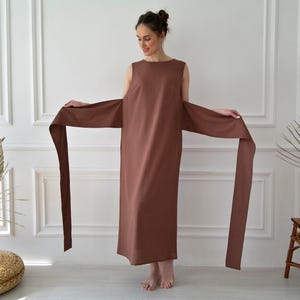 Women's kimono linen dress showing kimono-style sleeves, long waist ties, and relaxed fit