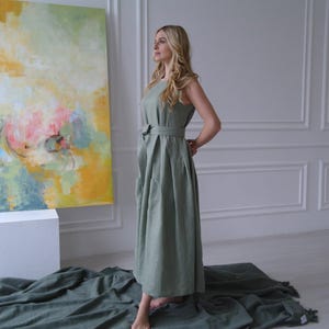 Women's pleated maxi linen dress showing richly pleated skirt and tie waist