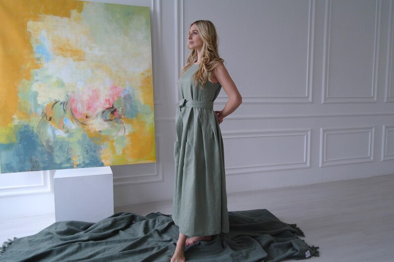 Women's pleated maxi linen dress showing richly pleated skirt and tie waist