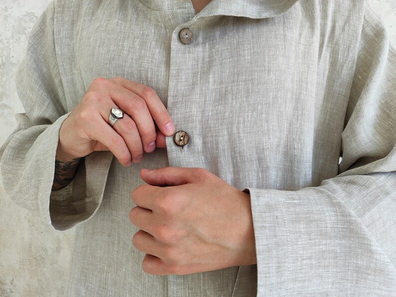 Men's Undyed Hooded Linen Kaftan with Button Front Side Slits and Deep Pockets, close-up showing the button detail and fabric texture of the undyed linen kaftan.
