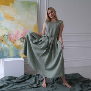 Women's pleated maxi linen dress showing pleated skirt and waist tie
