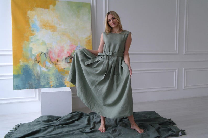 Women's pleated maxi linen dress showing pleated skirt and waist tie