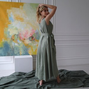 Women's pleated maxi linen dress side view showing waist tie and pleated skirt