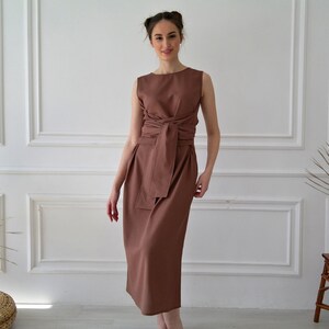 Women's kimono linen dress showing sleeveless, crew neckline, and waist tie