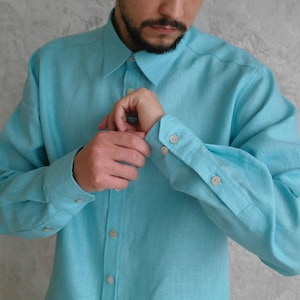 Men's Point Collar Linen Shirt, Natural Buttons and Long Sleeves, close-up detail showing the buttoned cuff of a turquoise linen shirt.