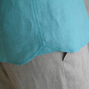 Men's Point Collar Linen Shirt, Natural Buttons and Long Sleeves, close-up showing the hem stitching on a turquoise linen shirt.