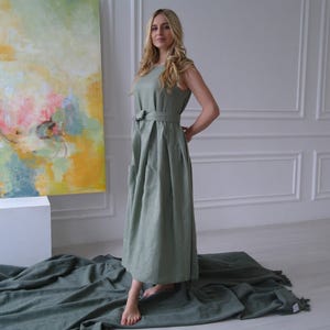 Women's pleated maxi linen dress showing waist tie and pleated skirt