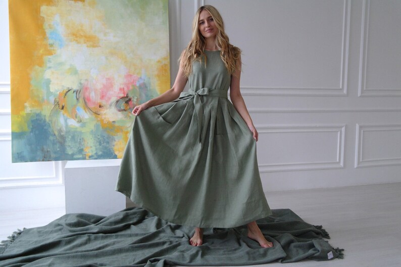 Women's pleated maxi linen dress showing waist tie, pleated skirt, and slightly dropped waist