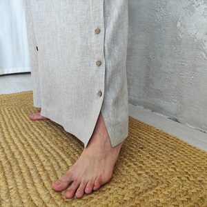 Men's Undyed Hooded Linen Kaftan with Button Front Side Slits and Deep Pockets, close-up showing the side slit with button closures on the linen kaftan.