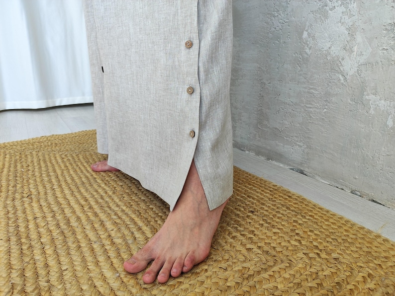 Men's Undyed Hooded Linen Kaftan with Button Front Side Slits and Deep Pockets, close-up showing the side slit with button closures on the linen kaftan.