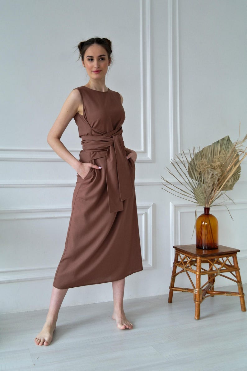 Women's kimono linen dress showing waist tie, side pockets, and relaxed fit