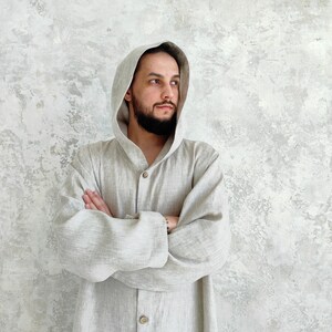 Men's Undyed Hooded Linen Kaftan with Button Front Side Slits and Deep Pockets, front view showing an undyed, hooded linen kaftan.