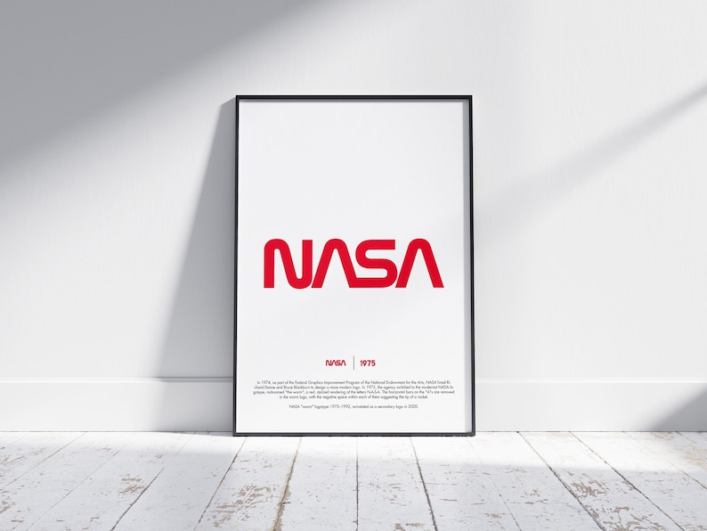 May include: A framed poster with a red NASA logo and the text "NASA | 1975". The poster includes a description of the logo's history.