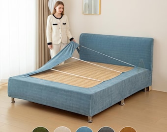 May include: A blue velvet-textured bed frame cover with a fitted design that wraps around the headboard and base. The cover features elastic straps for secure attachment, shown partially installed over a natural woven mat on the bed frame.