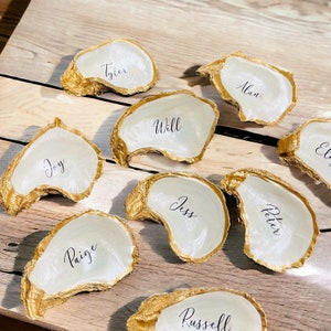 Plaatskaarten oesterschelp, plaatskaarten bruiloft, plaatskaarten, plaatskaarten Oyster met gouden rand, plaatskaarten bruiloft, huwelijksbedankjes, huwelijksdecor, ceremonie aan zee