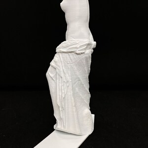 May include: A white 3D printed statue of the Venus de Milo, a famous Greek sculpture, standing on a white base.