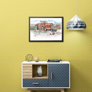 May include: A framed watercolour painting depicting an orange construction vehicle with a forklift. The artwork includes orange traffic cones. The painting is displayed on a yellow wall. The painting is in a black frame.