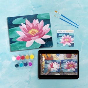 May include: A water lily painting kit with a canvas, paint, brushes, and a video tutorial. The canvas shows a pink water lily with green leaves. The video tutorial shows a person painting a water lily.