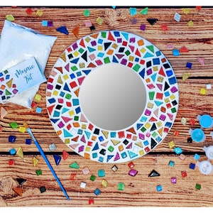 May include: A colorful mosaic mirror kit with a white background, a bag of white glue powder, and four bottles of glue. The mirror is surrounded by colorful glass tiles in various shapes and sizes.