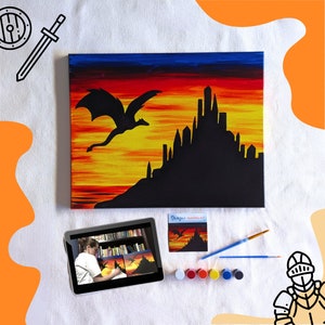 May include: A paint-by-numbers kit featuring a black silhouette of a dragon flying over a castle against a sunset background. The kit includes a canvas, paint, brushes, and a small instruction card.