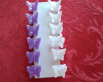 May include: A set of 10 butterfly hair clips, 5 purple and 5 white. The clips are arranged in two rows on a white background.