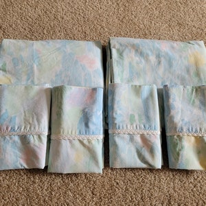 May include: A set of six blue and white floral patterned pillowcases. The pillowcases have a white lace trim.