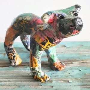 May include: A set of three ceramic mugs with a speckled, matte finish. The mugs are in shades of cream, light gray, and dark gray. Each mug has a simple, modern design and a rounded handle. Perfect for coffee or tea.