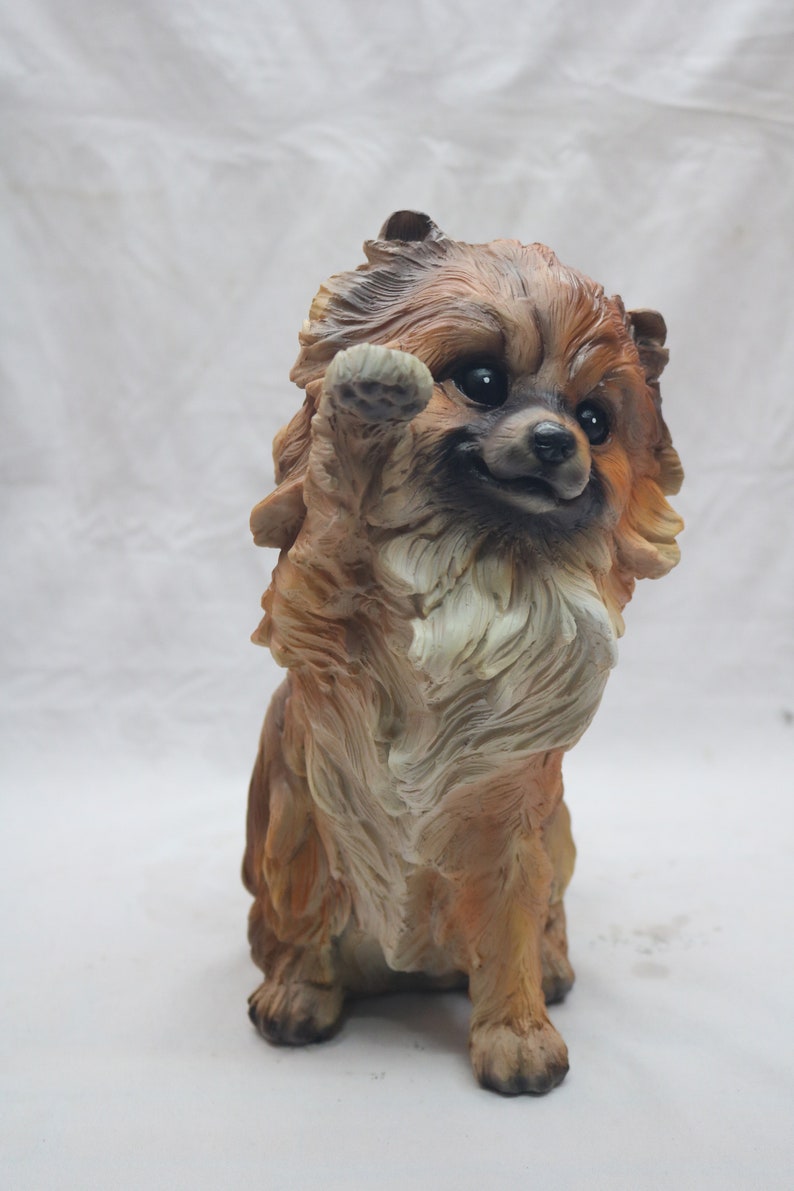pomeranian statue with wings
