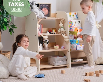 May include: A light-colored wooden bookshelf with multiple shelves, filled with children's books, toys, and a gray storage bin. Two young children are interacting with the bookshelf and toys. The bookshelf is in a room with a neutral-colored rug.